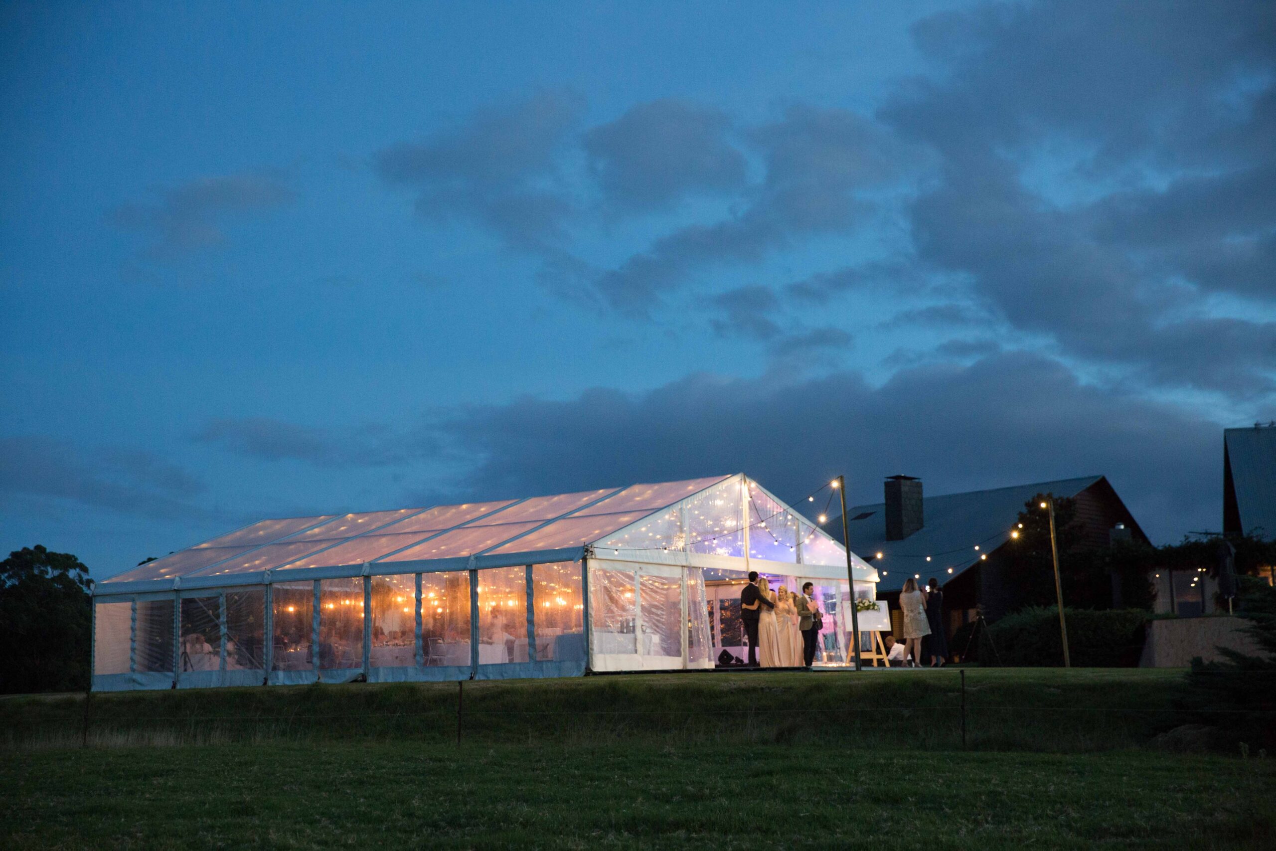 Event setup with hired tables and chairs under a marquee